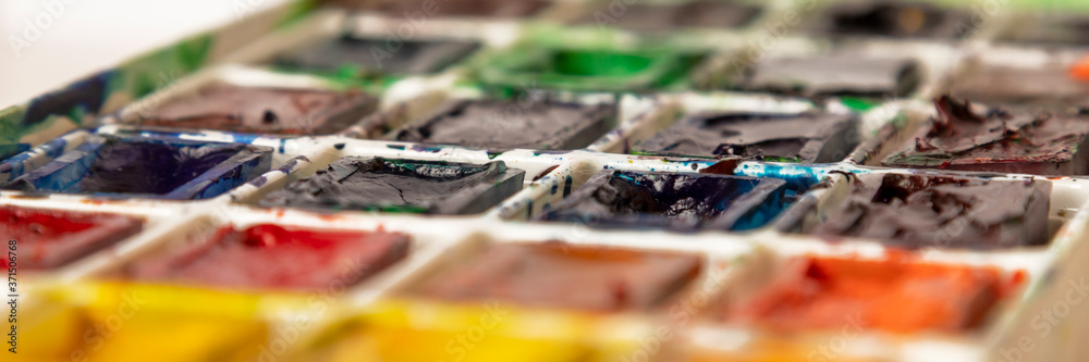 Art palette with colorful paints. Close-up view. Drawing circle.