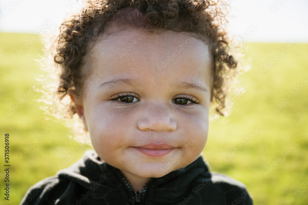 Close up of mixed race baby boy with curly hair Close up of mixed race baby boy with curly hair