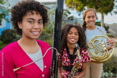 Pacific Islander girls holding musical instruments photo