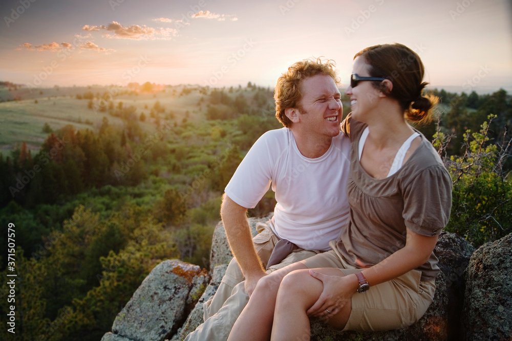 Caucasian couple hugging on remote hilltop Caucasian couple hugging on remote hilltop