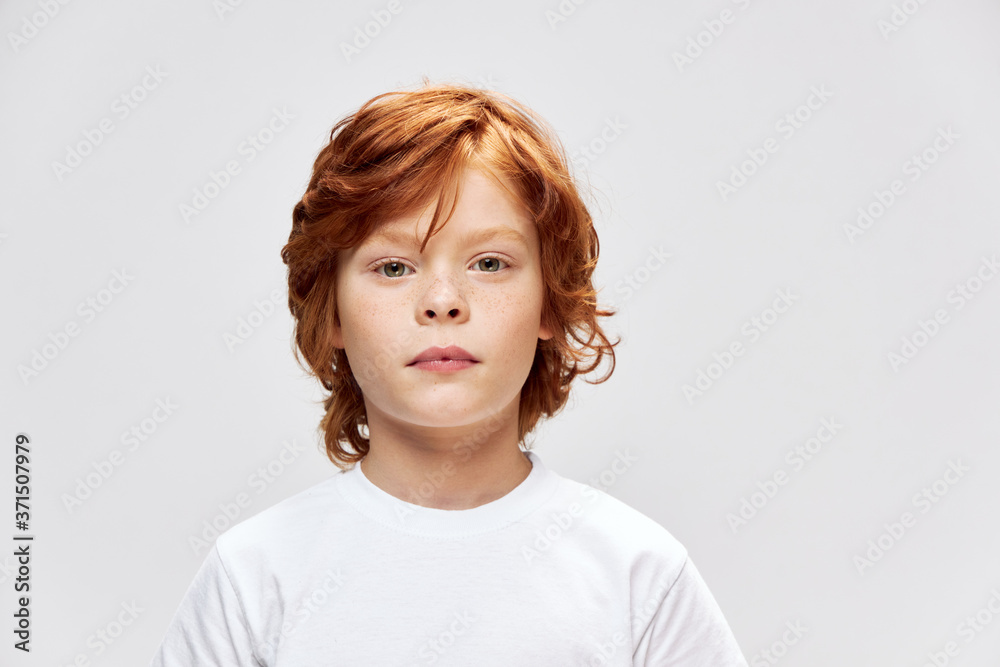 portrait of a boy k wearing a white t-shirt Look forward cropped view portrait of a boy k wearing a white t-shirt Look forward cropped view