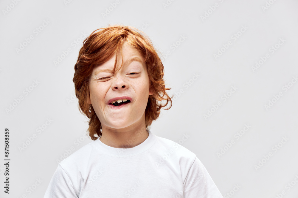 grimacing redhead boy with open mouth squints eyes cropped view gray grimacing redhead boy with open mouth squints eyes cropped view gray