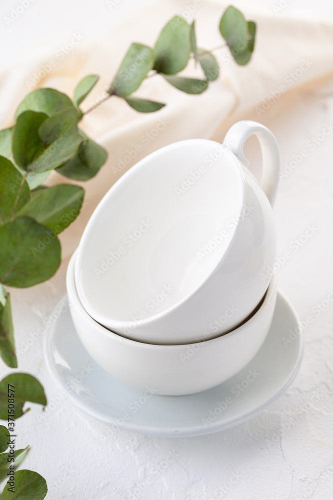 two empty white cappuccino cups on a light background. two empty white cappuccino cups on a light background.