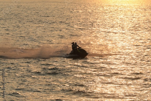 Silhouette of couple riding a watercraft © Douglas