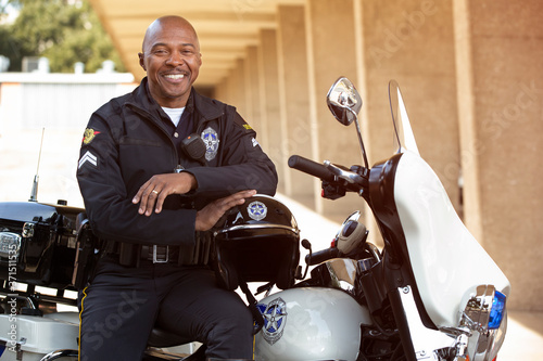 Portrait of police officer sitting on his motorcycle photo