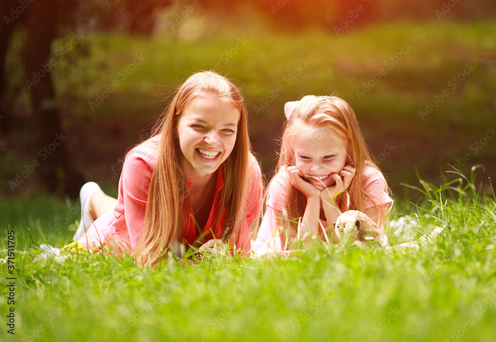 Mother and daughter having fun together in forest park on nature, children's education Mother and daughter having fun together in forest park on nature, children's education