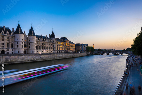 Cruise ship in Seine river against clear blue sky during sunrise, Paris, France