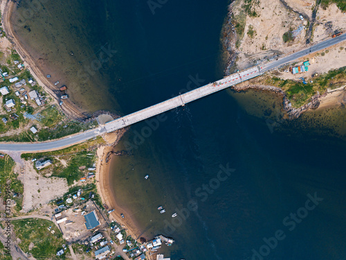 Russia, Murmansk Oblast, Teriberka, Aerial view of coastal village bridge photo