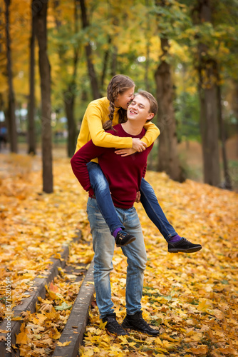happy young couple having fun and walking in the autumn Park