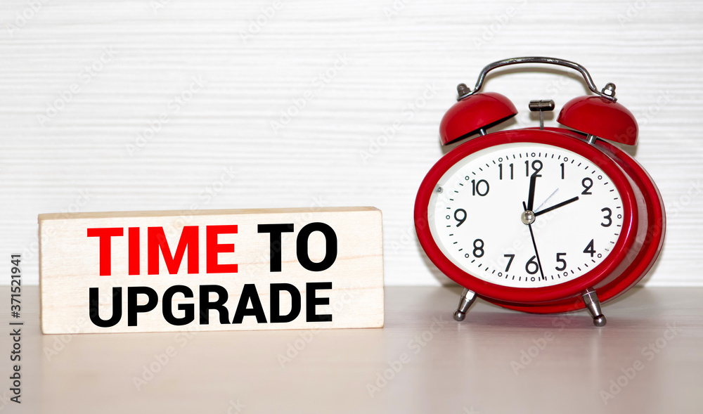 Alarm clock and text Time to Update. Time to Update concept. Time to Update concept clock closeup on white background with red and black words Alarm clock and text Time to Update. Time to Update concept. Time to Update concept clock closeup on white background with red and black words