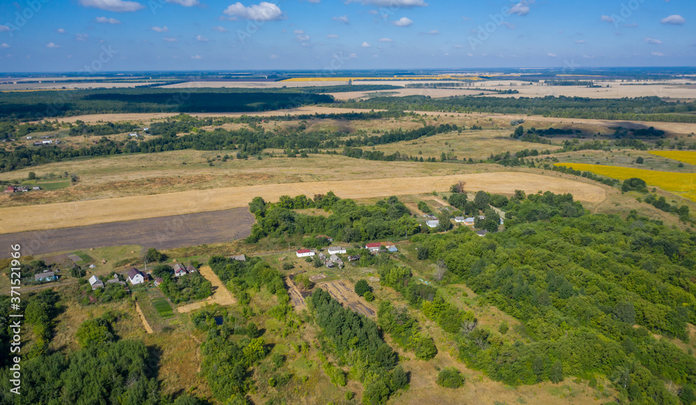 aerial photography of a village located among forests and fields