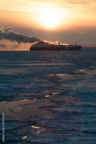 Icebreaking LNG vessel sails though the ice field