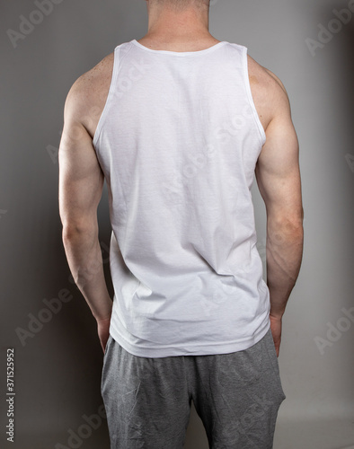 Back of muscular young man in athletic clothing © Sharon