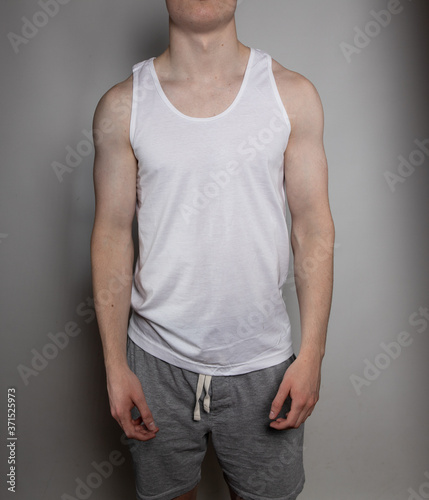 Torso of young man in athletic clothing in studio