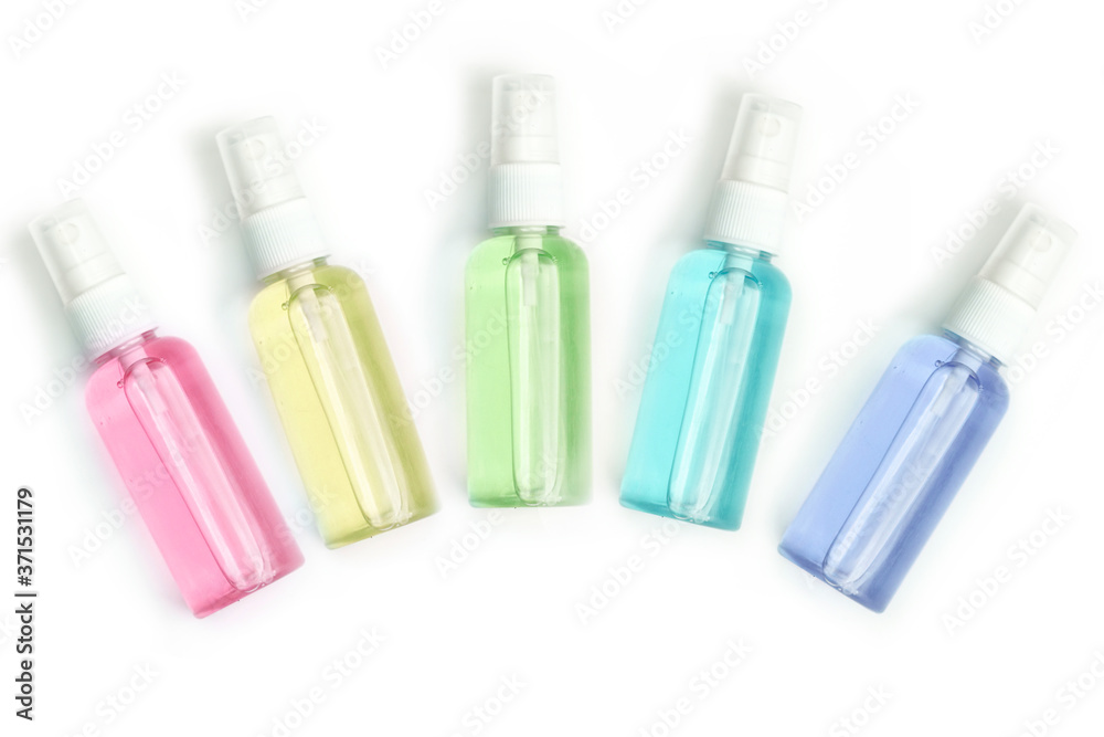 five multi-colored spray bottles made of plastic, with hand sanitizer. White background five multi-colored spray bottles made of plastic, with hand sanitizer. White background