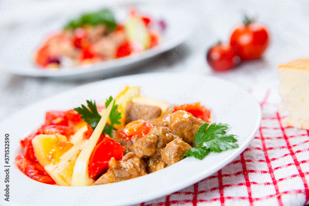 cooked meat with tomatoes and potatoes cooked meat with tomatoes and potatoes