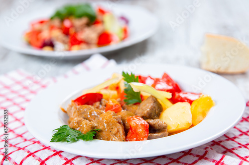 cooked meat with tomatoes and potatoes