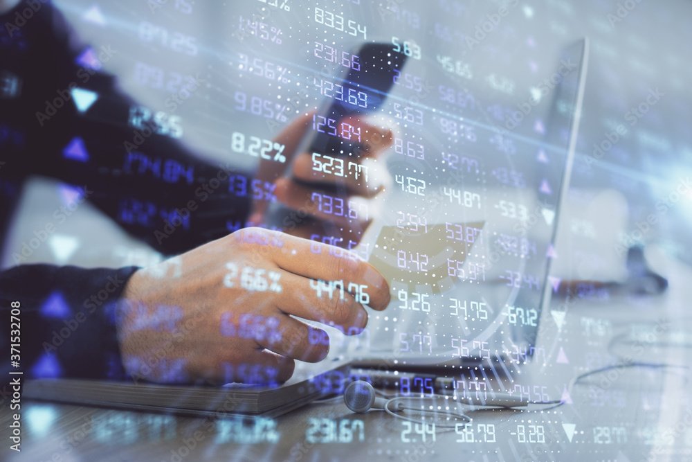 Double exposure of man's hands holding and using a phone and financial graph drawing. Analysis concept. Double exposure of man's hands holding and using a phone and financial graph drawing. Analysis concept.