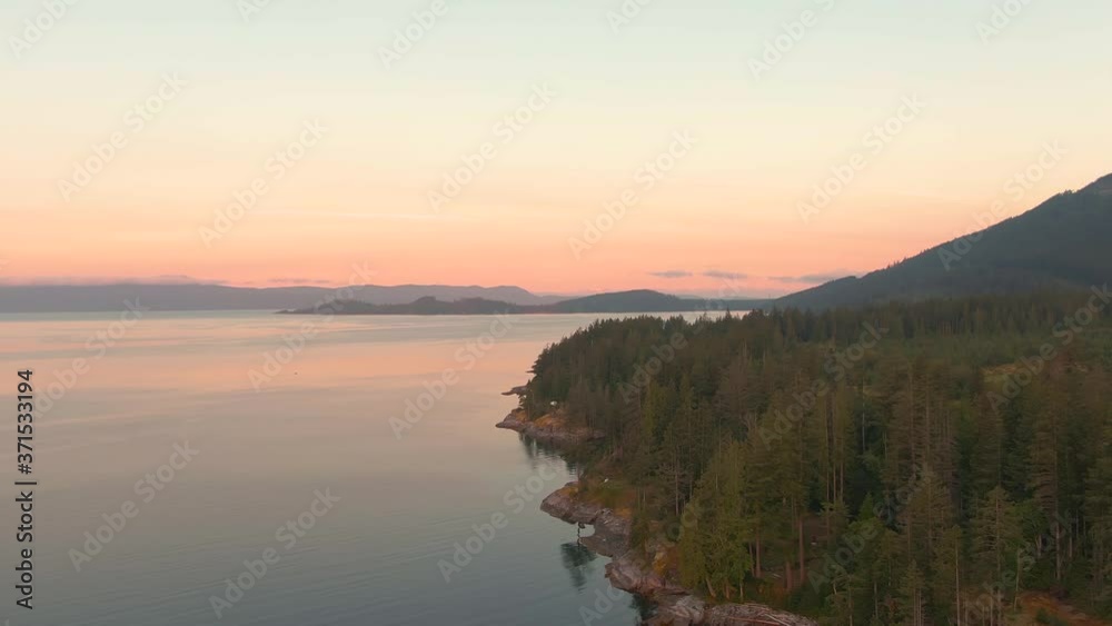 Aerial View of Mermaid Cove during a colorful summer sunrise. Taken in Saltery Bay, Sunshine Coast, British Columbia, Canada. Aerial View of Mermaid Cove during a colorful summer sunrise. Taken in Saltery Bay, Sunshine Coast, British Columbia, Canada.
