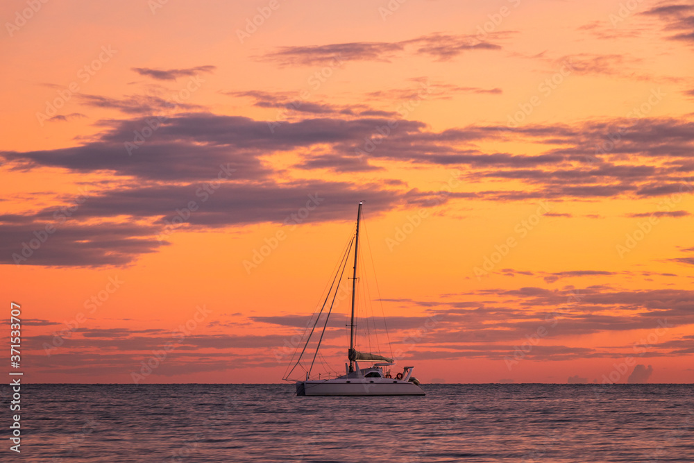 Yacht sailing at sunrise