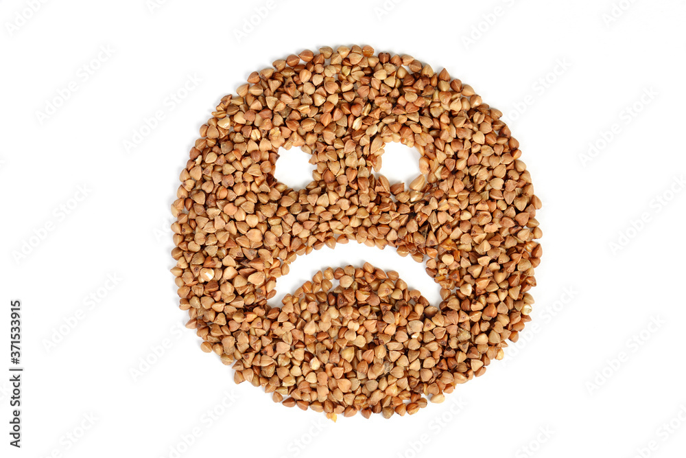 isolated on a white background, an evil smiley face, with eyes and a sad smile, is made of fresh buckwheat isolated on a white background, an evil smiley face, with eyes and a sad smile, is made of fresh buckwheat