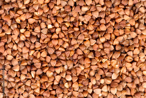 fresh buckwheat. dry buckwheat background. buckwheat texture. brown buckwheat is scattered on the surface