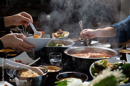 two people sharing hotpot photo