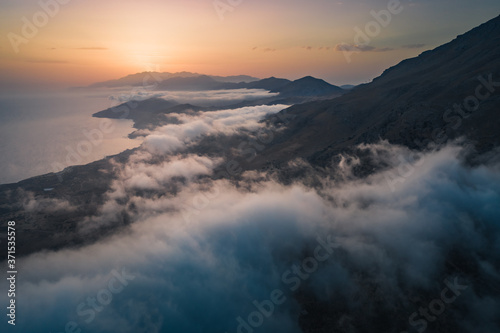 Sunset over the clouds and rugged south coast of Crete