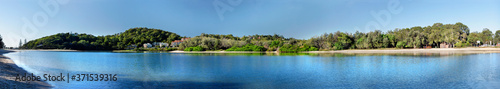 Large panoramic image of a lake in bright sunny day