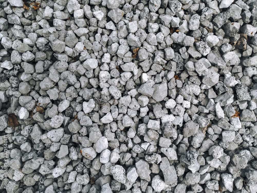 Slag in the form of small gray stones, top view. Waste rock during iron ore mining. Slag in the form of small gray stones, top view. Waste rock during iron ore mining.