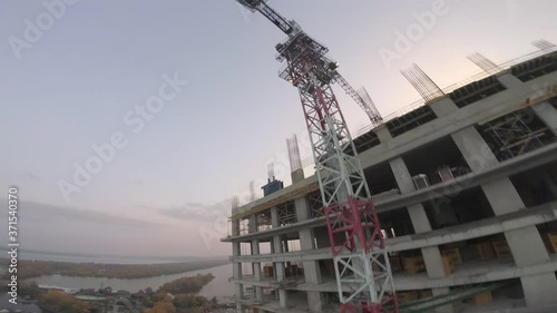 FPV drone is doing a flip and an extreme drop near a tall building photo
