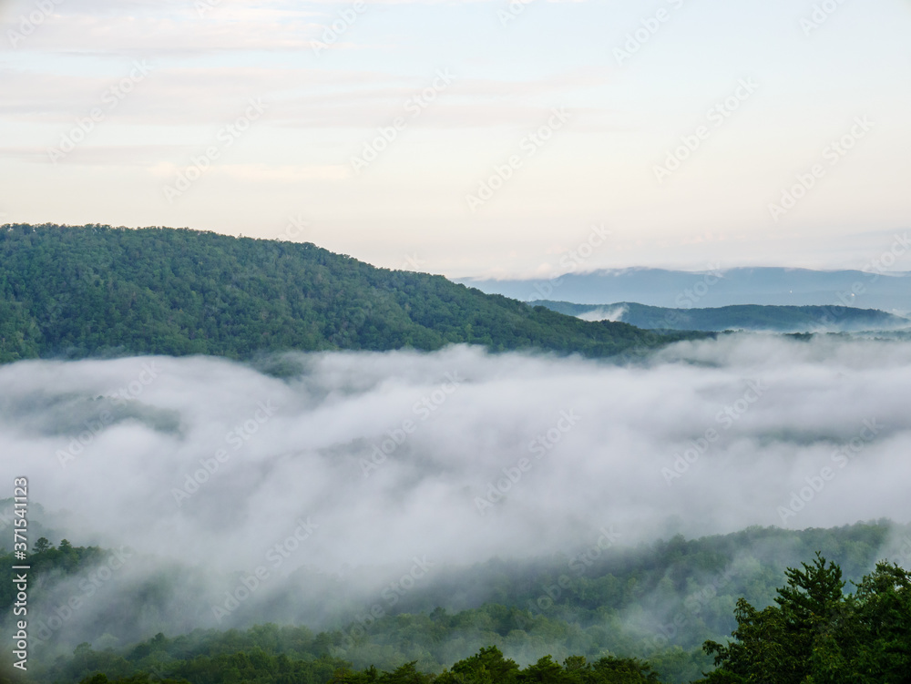 fog in the valley below a scenic overlook along the skyway motorway in the talladega national forest, alabama, usa