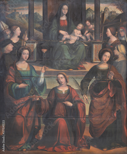 FERRARA, ITALY - JANUARY 30, 2020: The  painting of Madonna with the sains martyrs in church Chiesa di Santa Maria in Vado by Michele Coltellini (16. cent.).