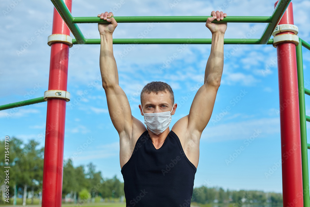 athletic man in a protective mask at practice in the morning