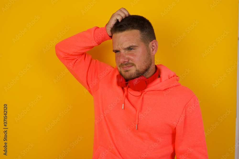 Oops, what did I do? Handsome blond man holding hand on head with frightened and regret expression. Wearing casual clothes standing against gray background. Oops, what did I do? Handsome blond man holding hand on head with frightened and regret expression. Wearing casual clothes standing against gray background.