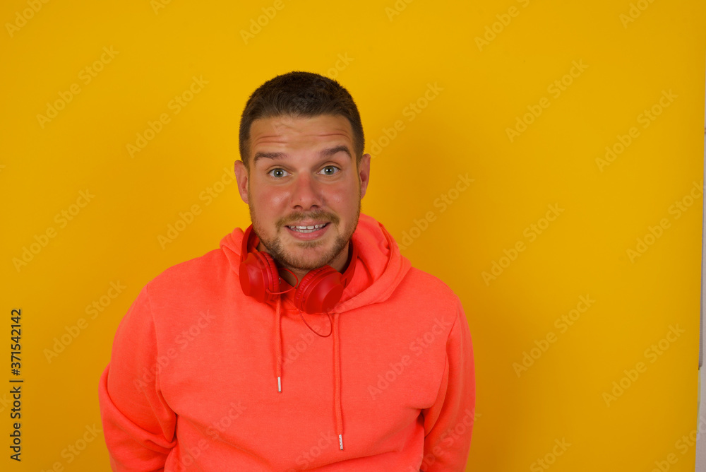 Young handsome man having broad white smile being excited to meet Friends and go out to have a good day. Young handsome man having broad white smile being excited to meet Friends and go out to have a good day.