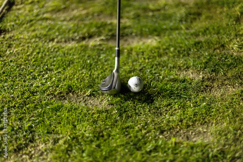 Golf ball on green grass ready to be struck
