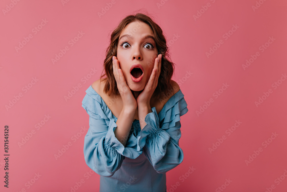 Shocked gorgeous woman looking to camera. Studio shot of attractive short-haired girl expressing amazement. Shocked gorgeous woman looking to camera. Studio shot of attractive short-haired girl expressing amazement.