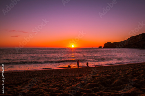Beautiful sunset at the beach in the village of Nazare, Portugal