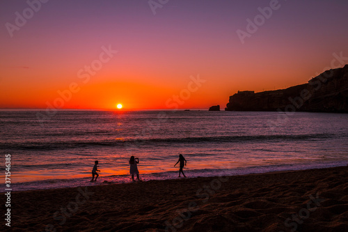 Fototapeta Naklejka Na Ścianę i Meble -  Beautiful sunset at the beach in the village of Nazare, Portugal