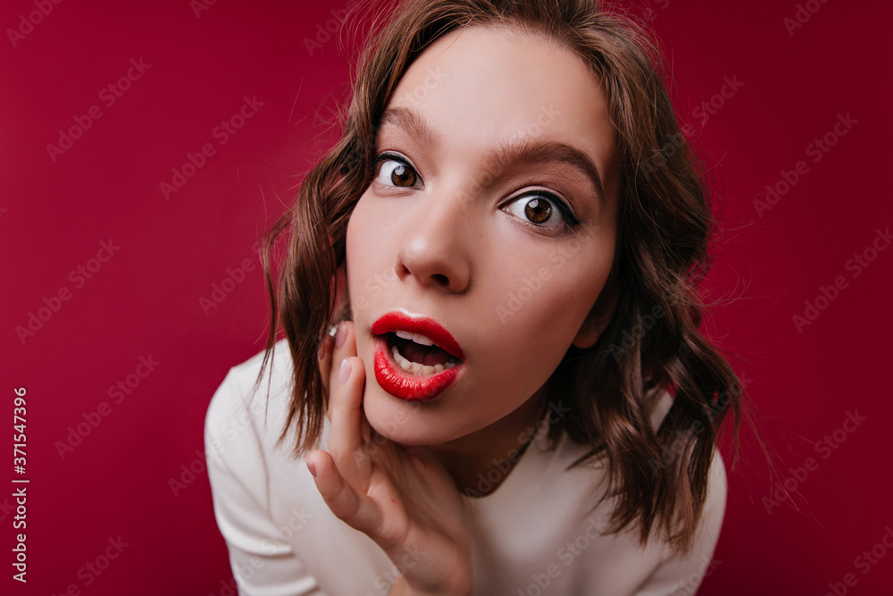 Close-up portrait of funny interested girl with dark eyes. Spectacular curly woman in white t-shirt looking to camera. Close-up portrait of funny interested girl with dark eyes. Spectacular curly woman in white t-shirt looking to camera.