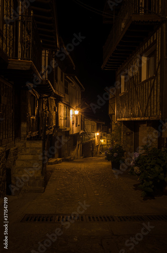 Streets of the village of Mogarraz illuminated at night, Salamanca, Spain