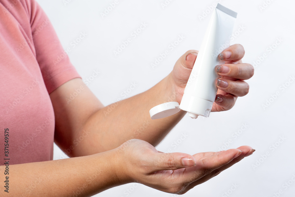 Asian women wash hands with alcohol gel isolated on white background, wear sanitary masks and have hand washing gels in new normal Asian women wash hands with alcohol gel isolated on white background, wear sanitary masks and have hand washing gels in new normal