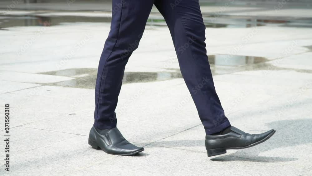 HD Slow motion of Confidence business man office worker legs in leather shoe and suit walking in the city to office building. Crowd business people employee going to work after raining. HD Slow motion of Confidence business man office worker legs in leather shoe and suit walking in the city to office building. Crowd business people employee going to work after raining.