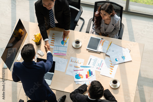 фотографія Group business people handshake at meeting table in office together with confident shot from top view
