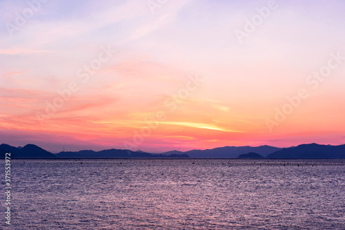 Beautiful seascape of sunset background orange color sky. © Chongbum Thomas Park
