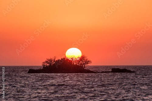 The fantastic sunset island and orange color sky.