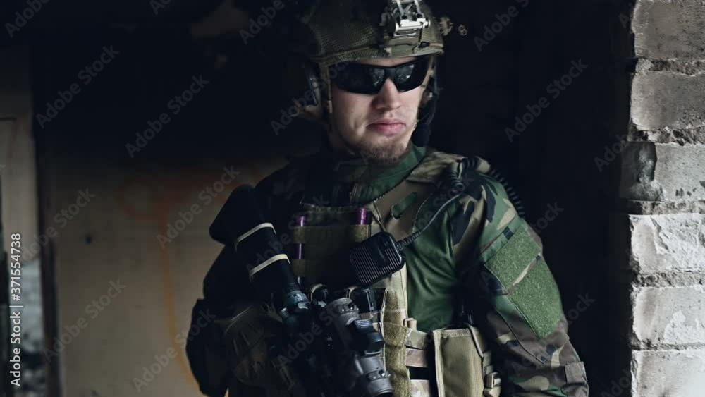 Close-up Shot of Fully Equipped Soldier Standing inside the building Close-up Shot of Fully Equipped Soldier Standing inside the building