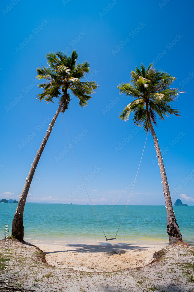 Beautiful beach and swing chair with coconut tree.
soft wave and sea view on beach. copy space. view from 