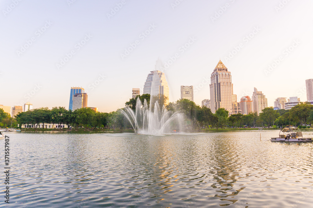 Lumpini park business district Bangkok cityscape from park with sunset sky Lumpini park business district Bangkok cityscape from park with sunset sky